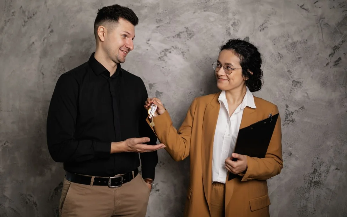 A property agent handing over keys to a new owner