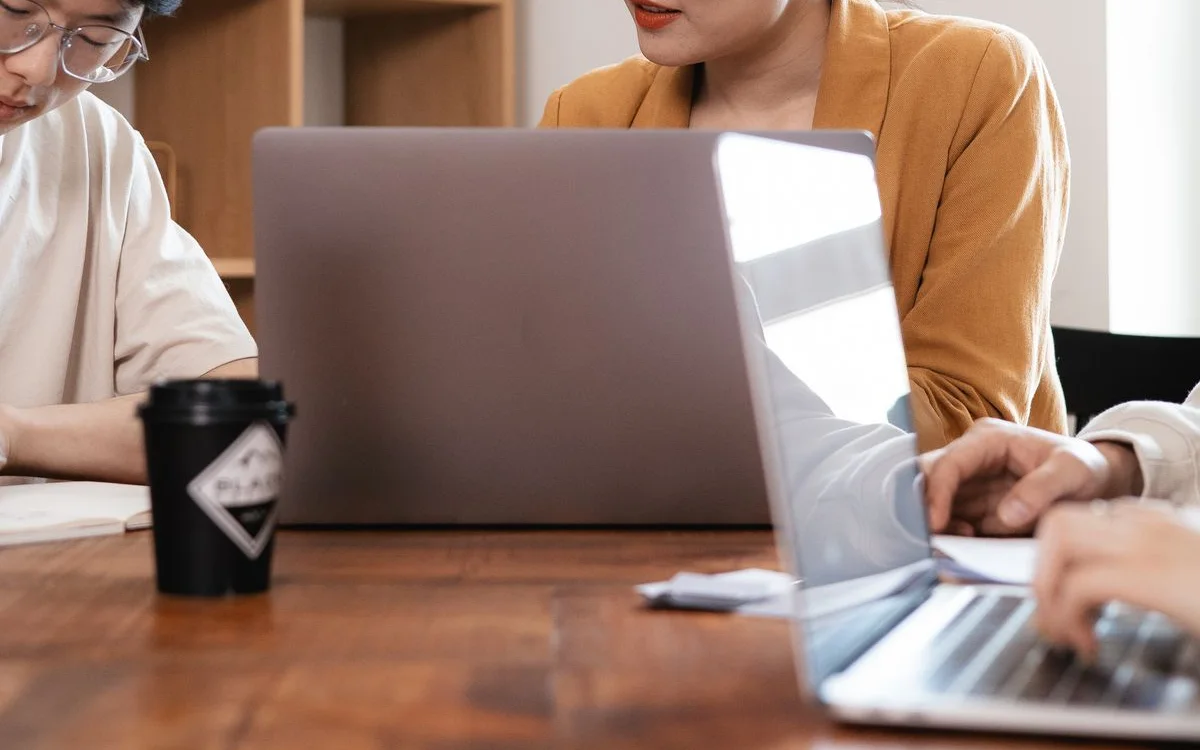 Two colleagues working together on a laptop