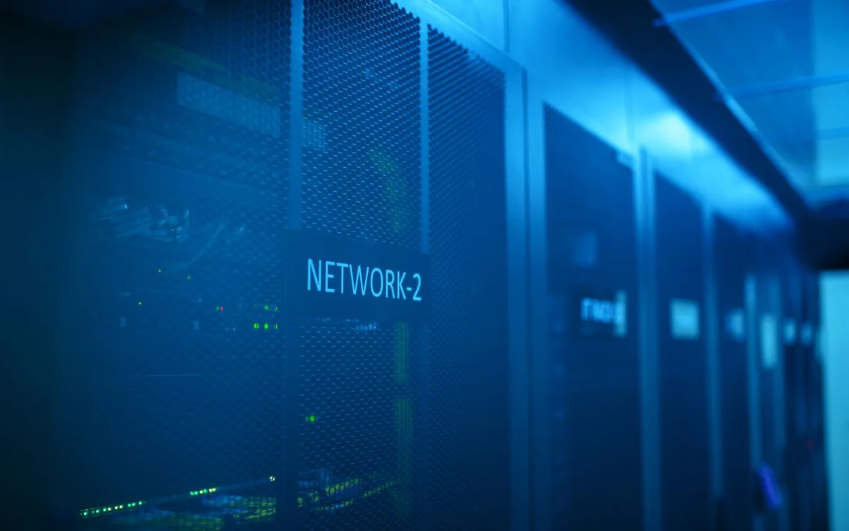 A network rack lit blue inside a server room