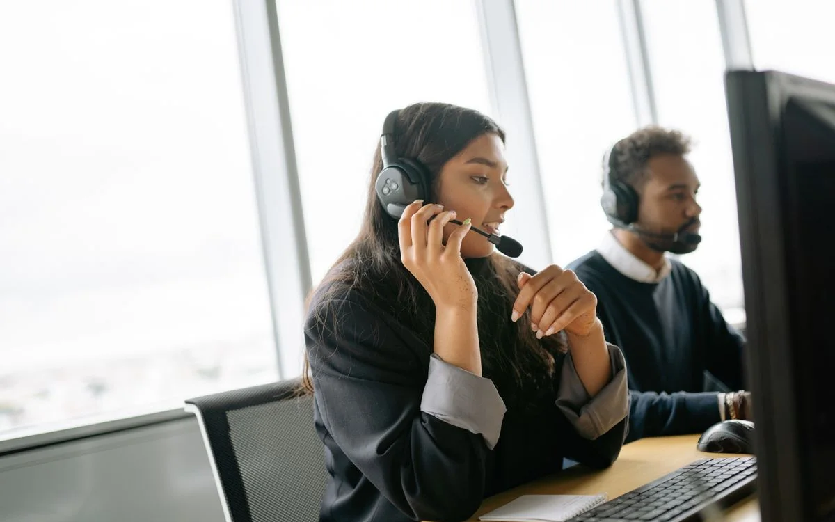 Customer support agents on calls in a bright office