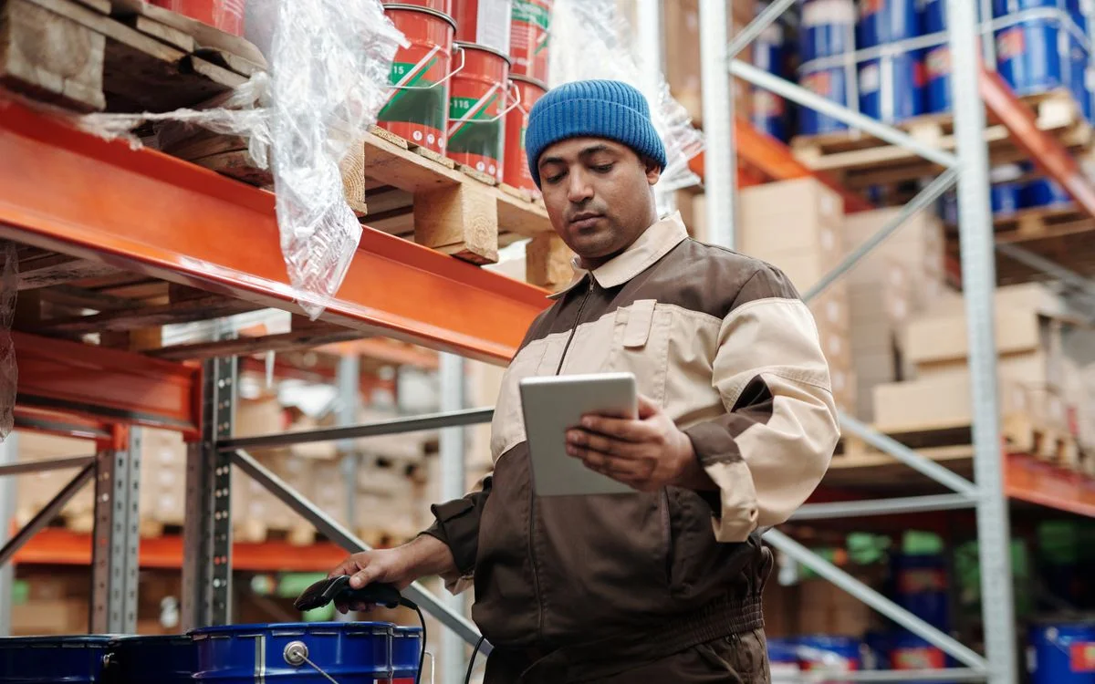 A warehouse worker checking stock on a tablet